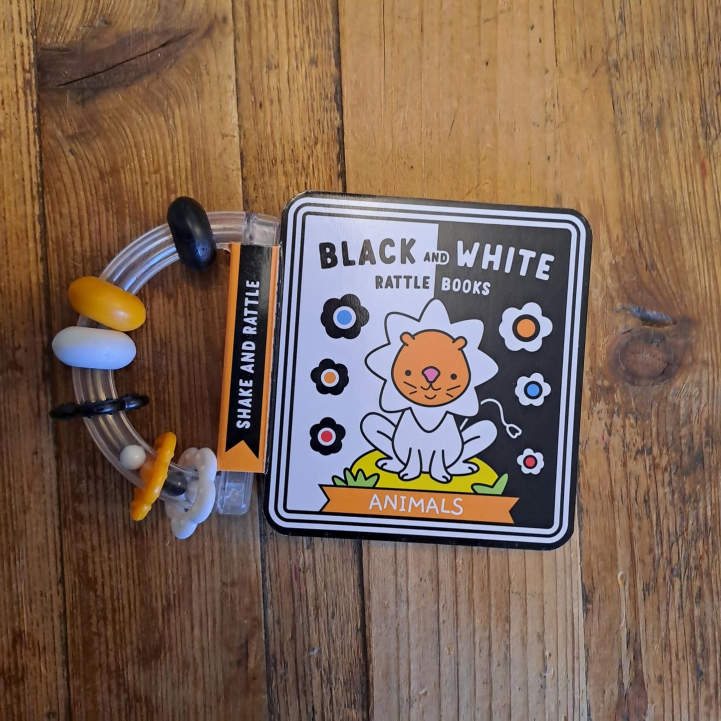 Toy with a card labeled 'Black and White' on a wooden surface