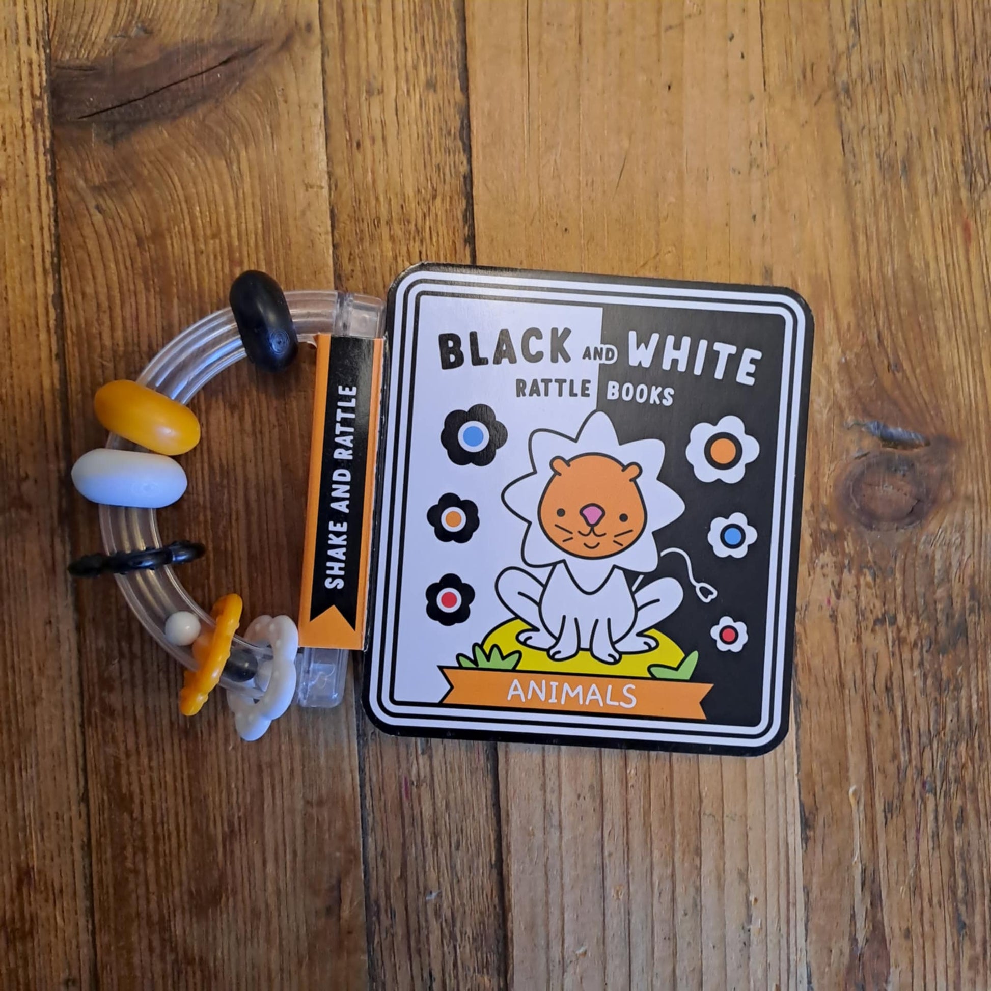 Toy with a card labeled 'Black and White' on a wooden surface