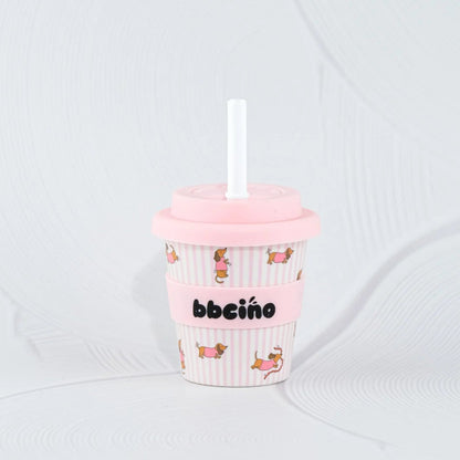 Pink cup with straw and 'bbeiño' branding on a white background