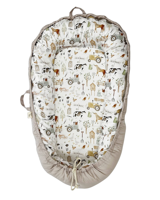 Baby nest with farm-themed pattern on a white background