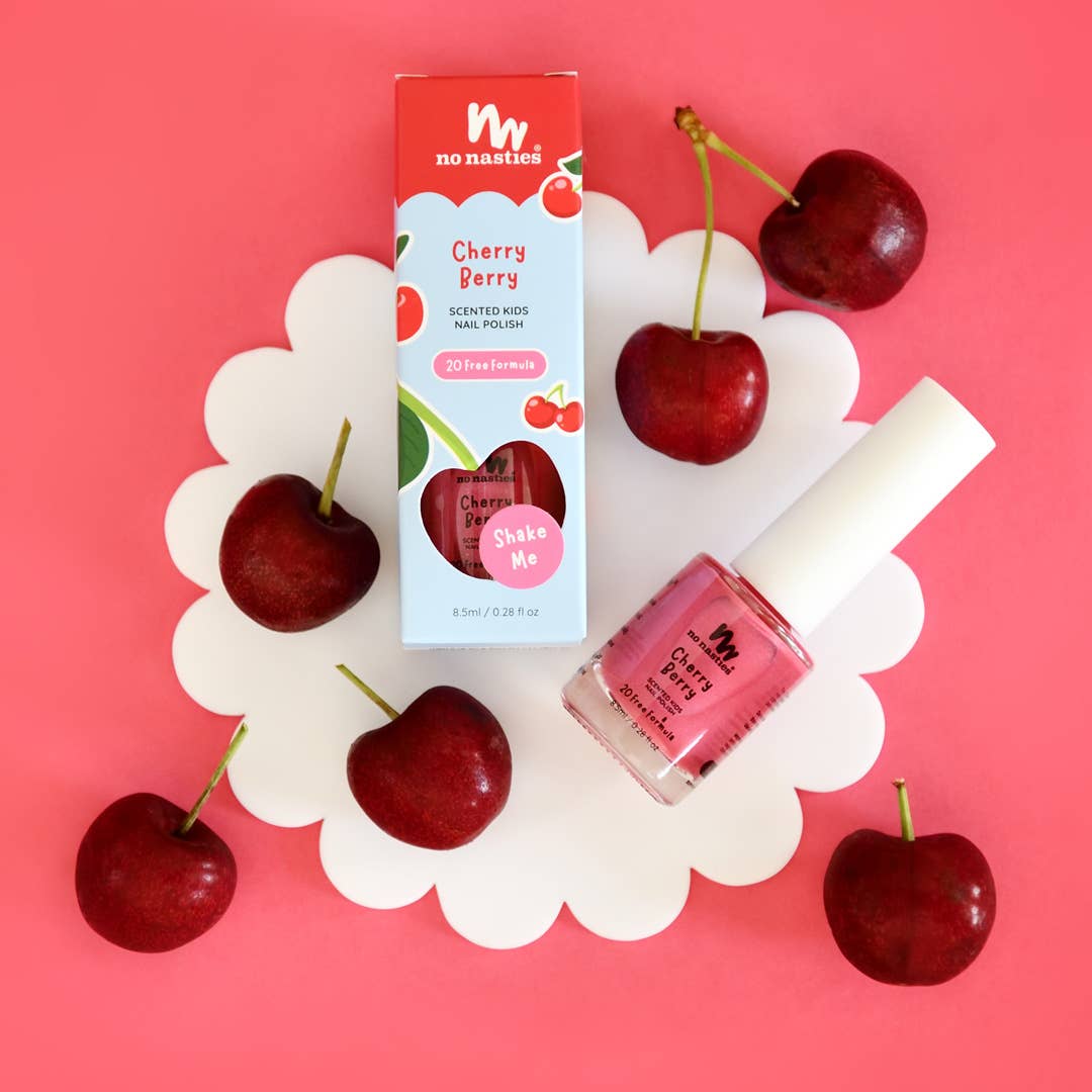 No Nasties Cherry Berry product with cherries and nail polish on a pink background