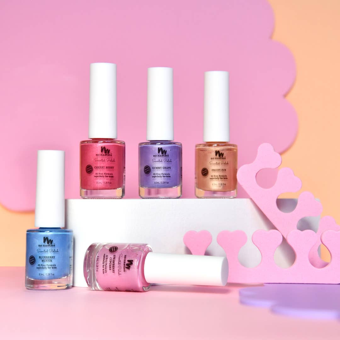 Set of nail polish bottles with a decorative pink and yellow background