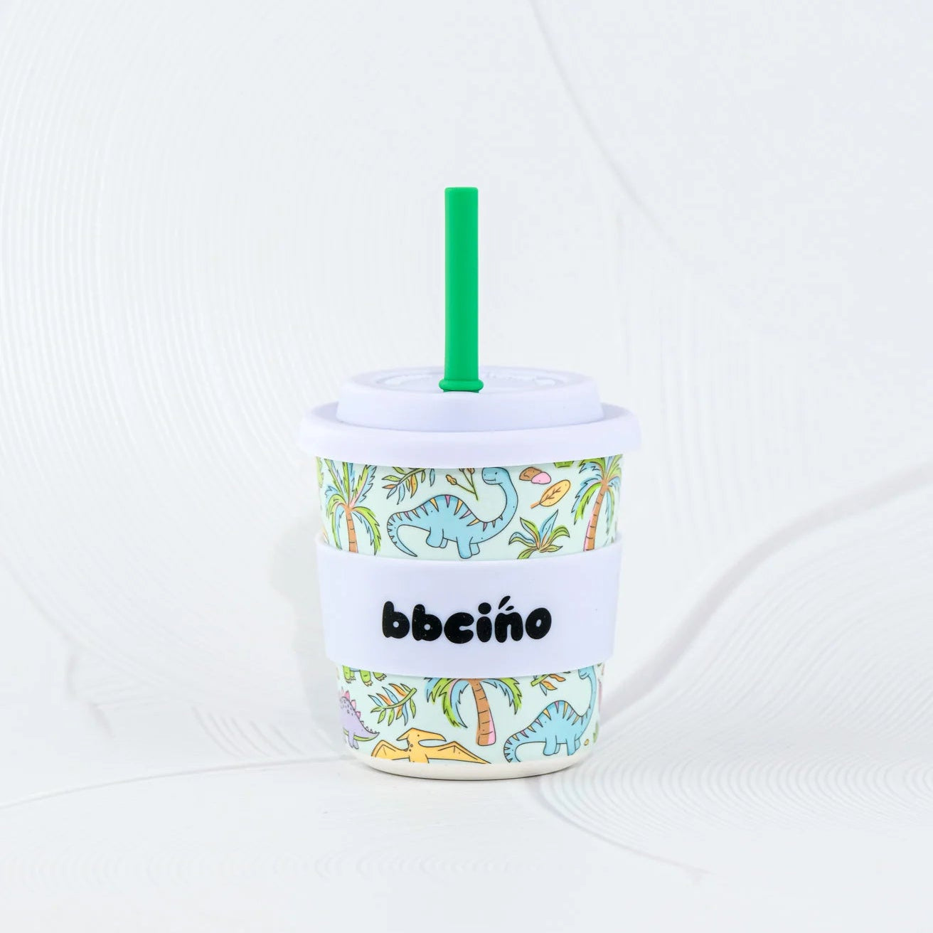 Bbeeino cup with dinosaur design and green straw on a white background