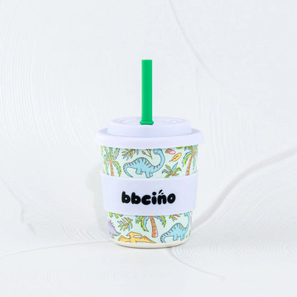 Bbeeino cup with dinosaur design and green straw on a white background
